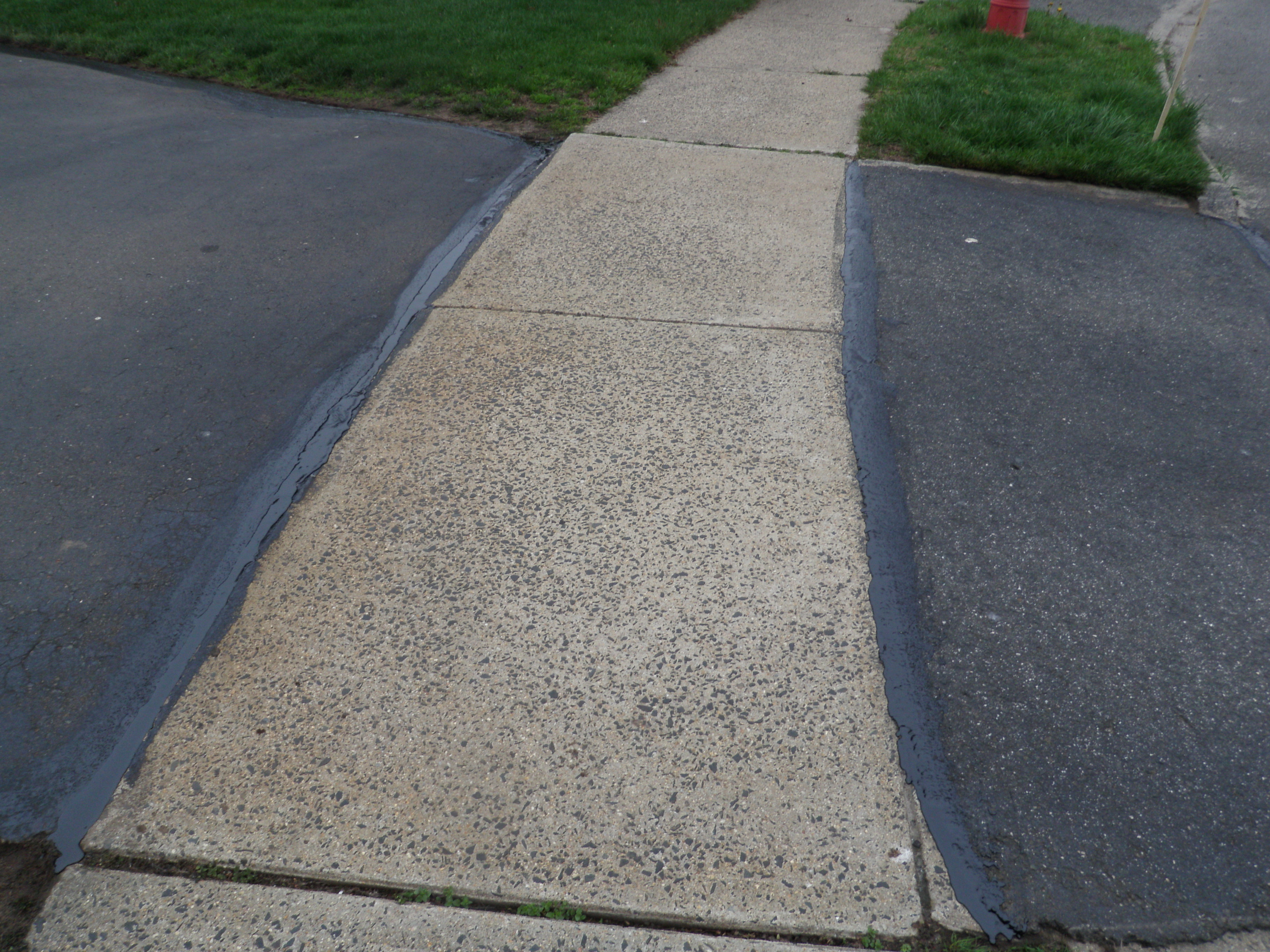 Driveway Sealant Each Side of Sidewalk