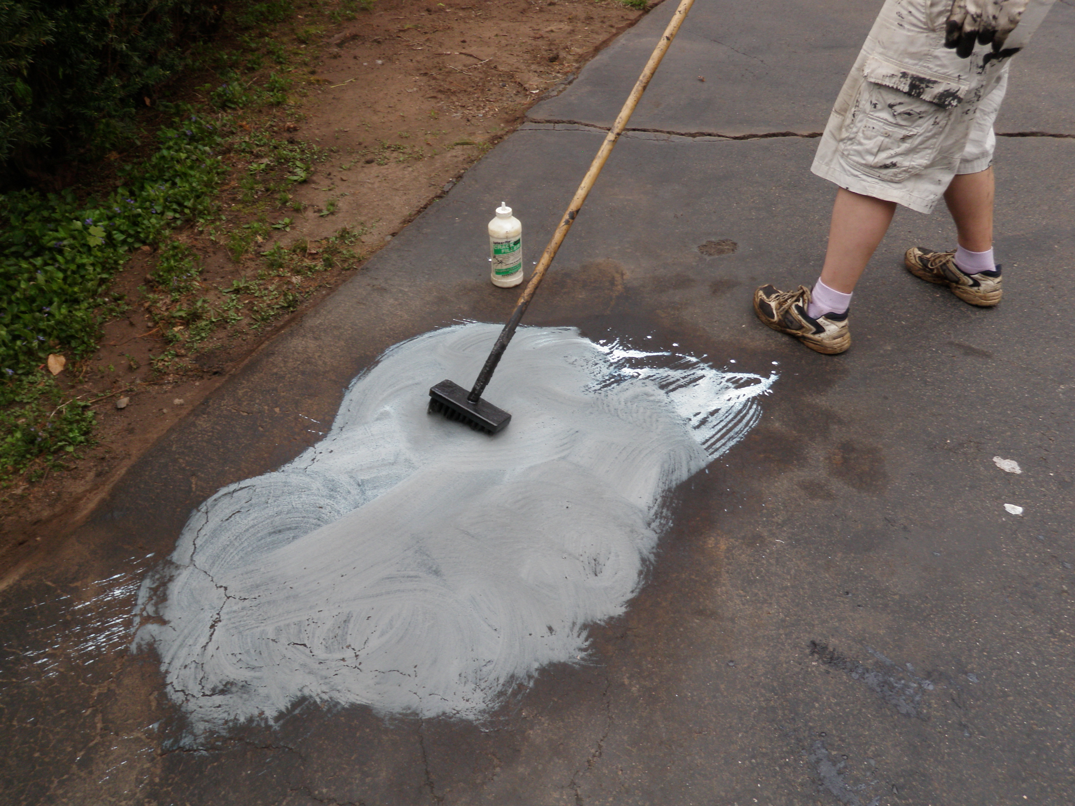 Scrubbing Driveway with Brush